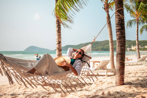 istock Relaxed Hispanic Woman Enjoying Beach Hammock Time 2159165116