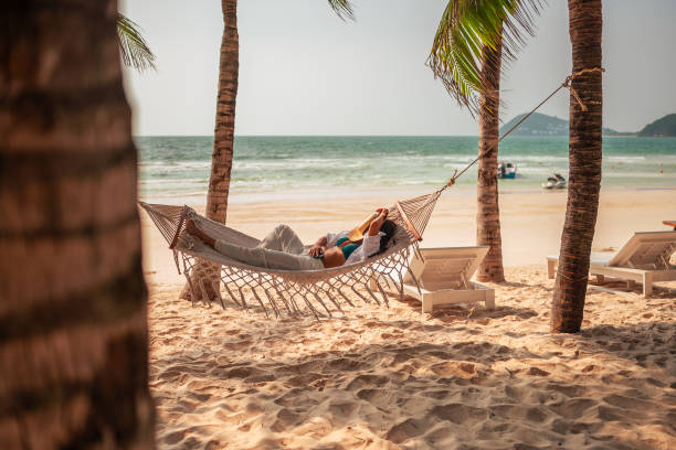 istock Relaxed Hispanic Woman Enjoying Hammock on Tropical Beach 2159165150