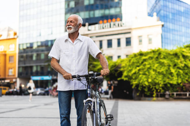 istock Mature men with commuting to work with his bicycle in city center. 2159165775