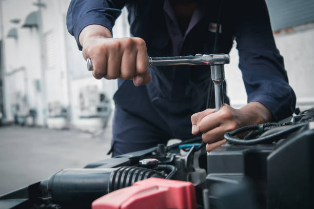istock Mechanic using wrench while working on car engine outside the service center , Repair and service. 2159167094