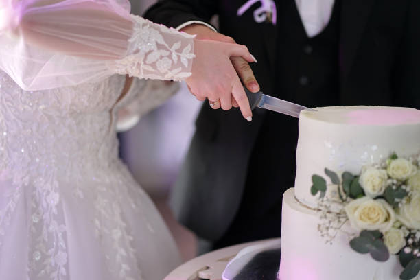 istock A beautiful white wedding torus decorated with white roses on a wooden stand. Wedding celebration. 2159173369