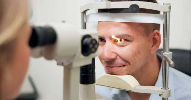 istock Optometrist, patient and assessment in clinic for eye exam, optometry and vision with ophthalmoscope. Specialist, man and machine in hospital for wellness, healthcare or ophthalmology for glaucoma 2159175348