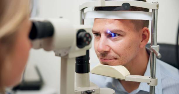 istock Optometrist, patient and assessment in clinic for eye exam, vision and optometry with ophthalmoscope. Specialist, man and machine in hospital for wellness, healthcare or ophthalmology for glaucoma 2159175350