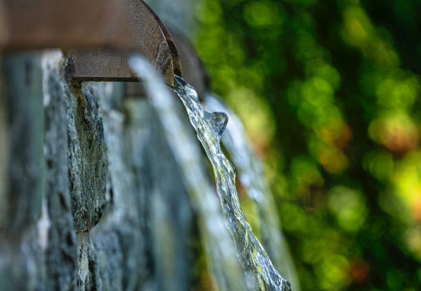 Water flowing down from three garden fountains