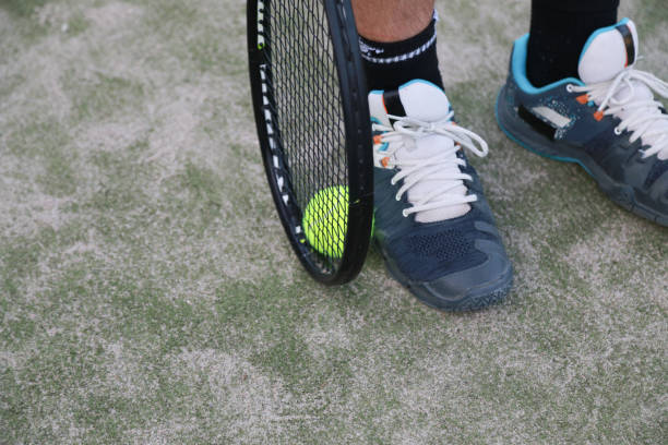 istock Tennis Player Picking Up The Ball From The Ground 2159176028