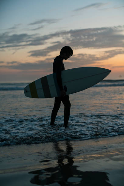 istock Man surfing in the morning ocean. 2159176103