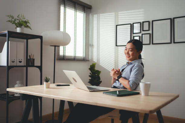 istock Asian woman enjoy with working online using laptop talking on video conference at home office. 2159176876
