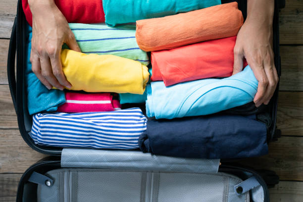 istock woman packing a luggage for a new journey 2159178763