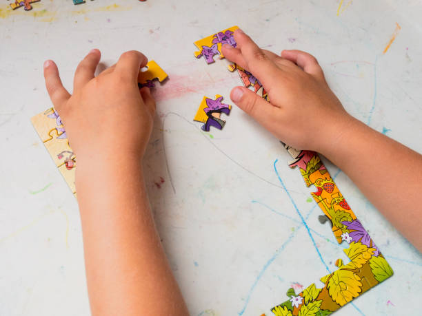 istock A small child, a preschool boy, collects mosaic puzzles 2159179862