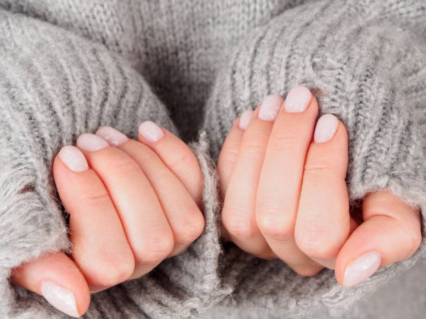 istock Women's manicure shellac soft pink color close-up 2159181365
