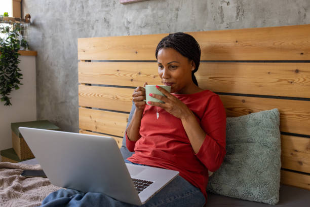 Woman Enjoying Laptop Time in Bed