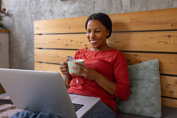 istock Woman Enjoying Laptop Time in Bed 2159184559