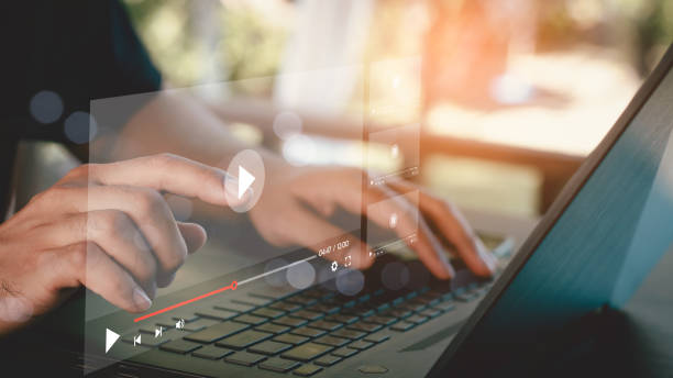 istock Man using mouse and keyboard to stream online on virtual screen. Video streaming on internet concept. Watch videos on the Internet, live concerts, performances or tutorials. online business content. 2159186032