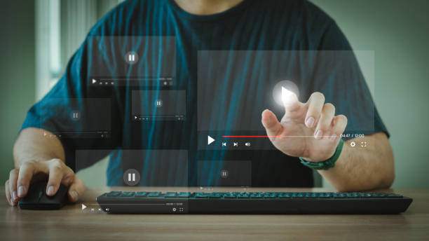 istock Man using mouse and keyboard to stream online on virtual screen. Video streaming on internet concept. Watch videos on the Internet, live concerts, performances or tutorials. online business content. 2159186060