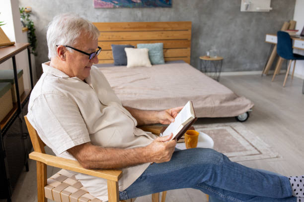 istock Senior man reading at home 2159186067