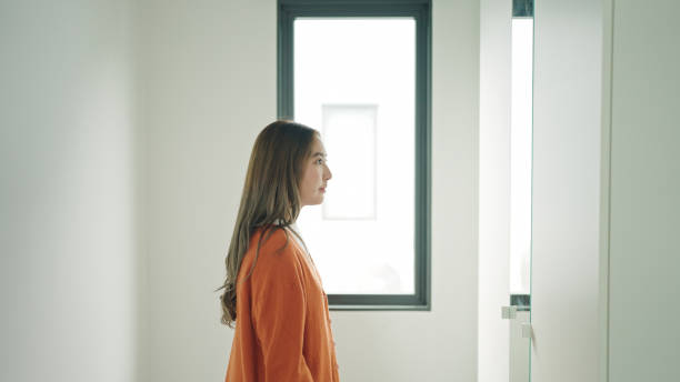 istock Woman looking at herself in the mirror. 2159187657