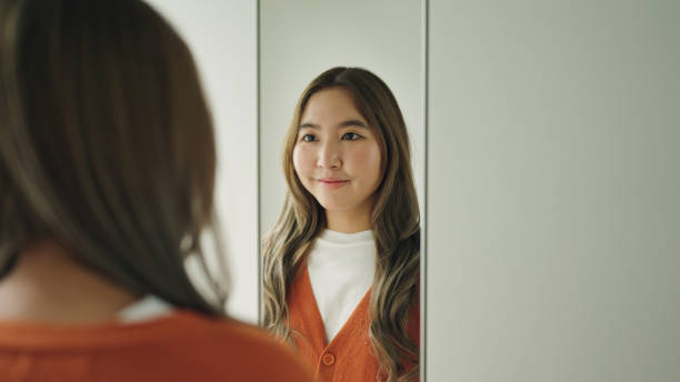 Woman looking at herself in the mirror.