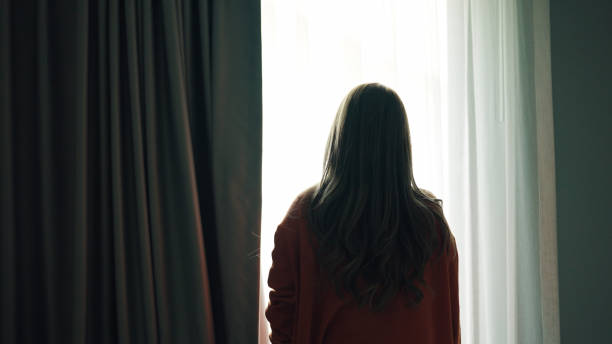 istock Woman opening curtain. 2159187738