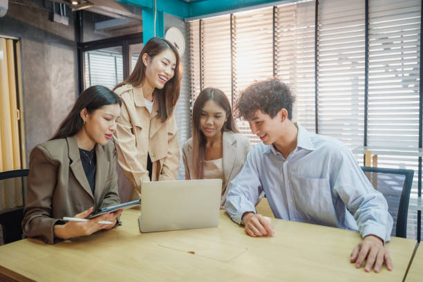 istock Working groups & Collaborations, Small group of young Asian people colleagues working together and discussing on new project at modern office 2159187875