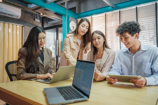 istock Working groups & Collaborations, Small group of young Asian people colleagues working together and discussing on new project at modern office 2159187888