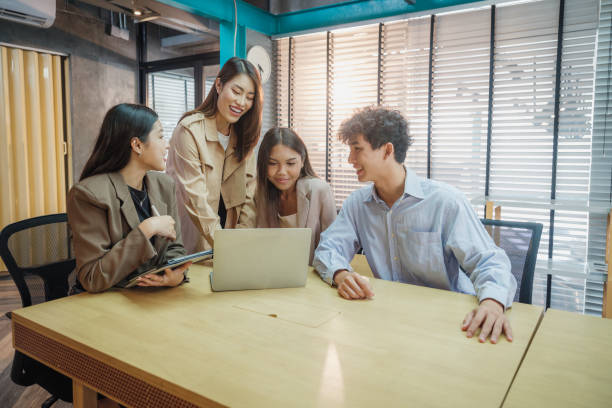 istock Working groups & Collaborations, Small group of young Asian people colleagues working together and discussing on new project at modern office 2159187896