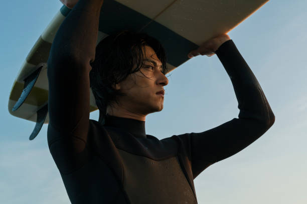 Man surfing in the morning ocean.