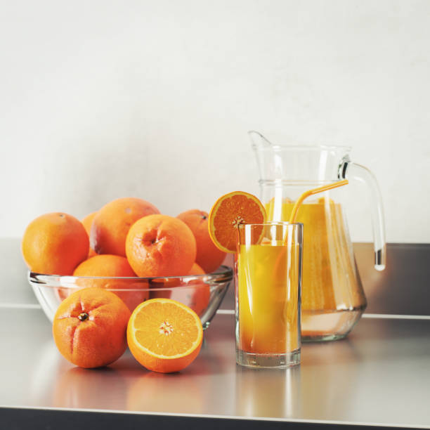 Digitally generated refreshing scene featuring a glass of freshly squeezed orange juice with a slice of orange, a pitcher, and a bowl of whole oranges on the counter. Perfect for representing healthy lifestyle, vitamin C, and fresh produce concepts.\n\nThe scene was created in Autodesk® 3ds Max 2025 with V-Ray 6 and rendered with photorealistic shaders and lighting in Chaos® Vantage with some post-production added.