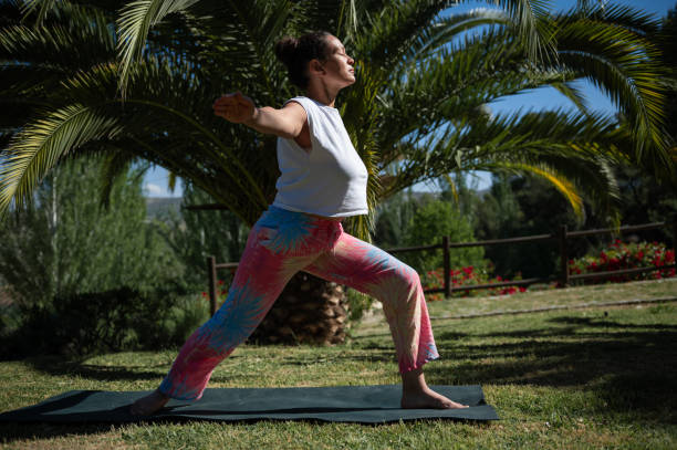 istock Woman practicing yoga in outdoor sunny garden setting 2159193713