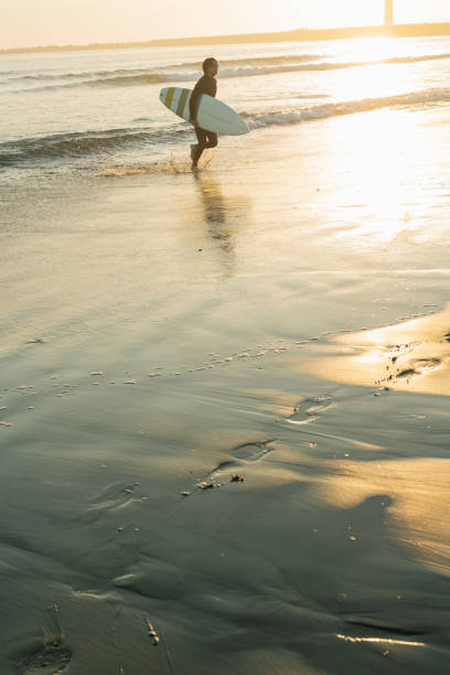 Man surfing in the morning ocean.