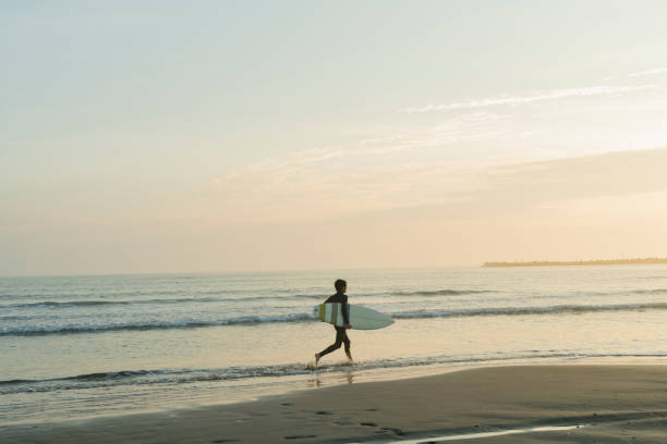 istock Man surfing in the morning ocean. 2159193906