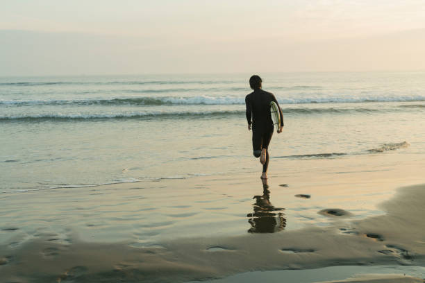 istock Man surfing in the morning ocean. 2159194064