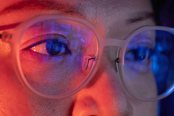 close up asian woman looking at computer screen with digital data information