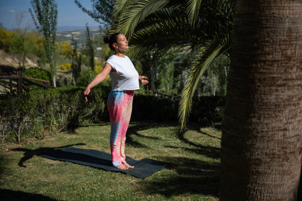 istock Woman practicing outdoor yoga in peaceful garden setting 2159195207