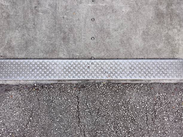 A Detectable Warning Surface sidewalk ensures safety for visually impaired pedestrians, featuring textured, high-contrast tiles that provide tactile cues and enhance urban accessibility.