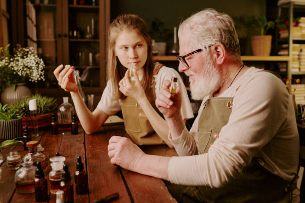 Senior Perfumer And His Young Helper Smelling Aroma