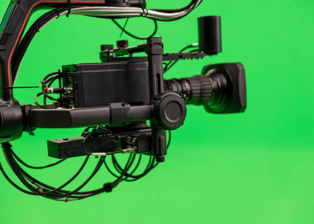 istock Black camera on carbon jib crane against green background. 2159202905