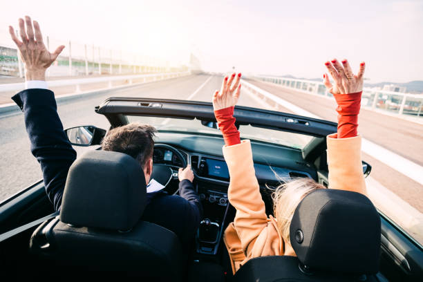 istock Middle age couple driving a car on road trip 2159203512
