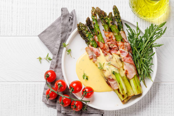istock Grilled asparagus with bacon and egg sauce on a plate 2159204297