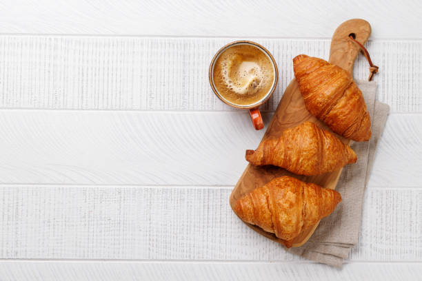 istock Cappuccino coffee and fresh croissants 2159206667