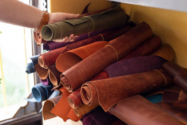 istock Professional crafter choosing leather in roll for making leather items 2159210714