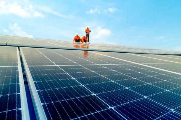 istock Male workers repair Floating solar panels on water lake. Engineers construct on site Floating solar panels at sun light. clean energy for future living. Industrial Renewable energy of green power. 2159213008