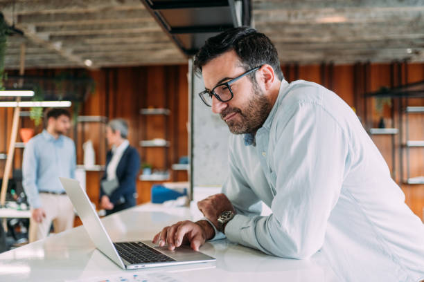 istock Successful businessman in modern office working on laptop. 2159213070