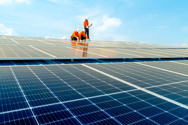 istock Male workers repair Floating solar panels on water lake. Engineers construct on site Floating solar panels at sun light. clean energy for future living. Industrial Renewable energy of green power. 2159213153