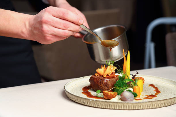 istock Preparing luxury grilled steak on plate with vegetables 2159213170
