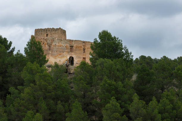 istock Landscape with clouds in the forest and ruined medieval building among pine trees 2159215736