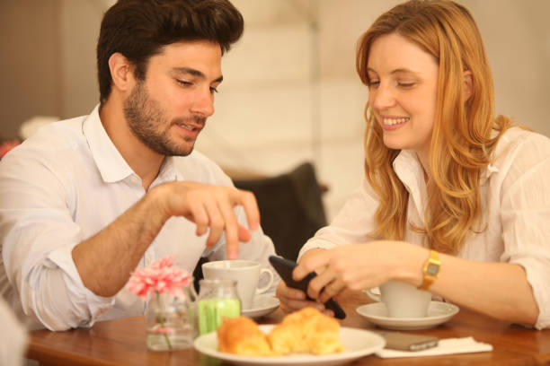 istock Happy young couple having fun and taking, drinking coffee indoors 2159221442