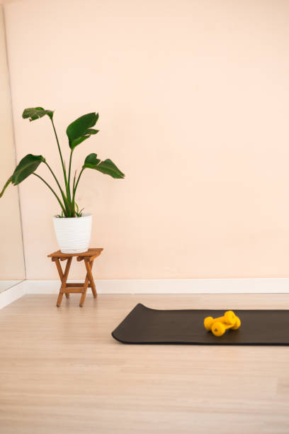 istock Yellow dumbbells on a black mat 2159223052