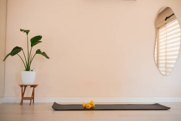 istock View of sport studio with a mat and dumbells 2159223748