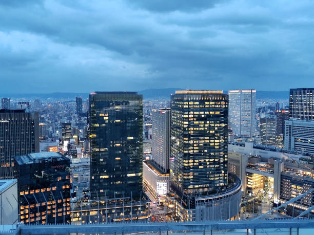 Office buildings and the Osaka cityscape at dusk, viewed from the Umeda Sky Building, a two-tower landmark skyscraper height 170 mt, located in the outskirts of Umeda business district in Kita-ku, Osaka.