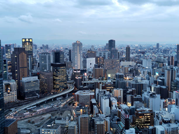Lighten Osaka cityscape at dusk, viewed from the Umeda Sky Building, a two-tower landmark skyscraper height 170 mt, located in the outskirts of Umeda business district in Kita-ku, Osaka.